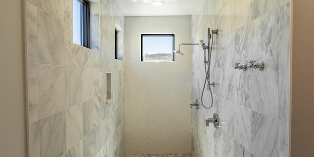 bathroom with a tile shower