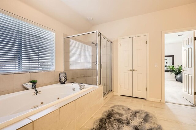 full bath featuring a shower stall and a tub with jets