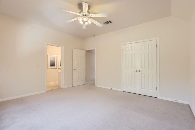 unfurnished bedroom with visible vents, baseboards, light colored carpet, and a closet