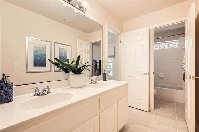 full bath with plenty of natural light, visible vents, and a sink