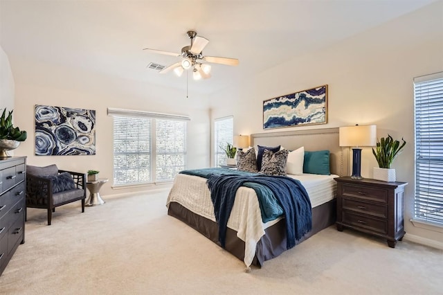 bedroom with ceiling fan, baseboards, visible vents, and light carpet