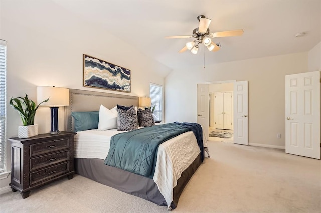 bedroom with baseboards, light carpet, lofted ceiling, and ceiling fan