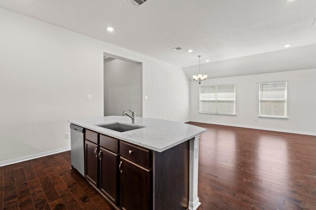 kitchen with dark wood-type flooring, a sink, stainless steel dishwasher, an inviting chandelier, and light stone countertops