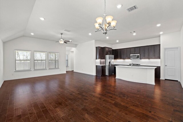 kitchen with open floor plan, ceiling fan with notable chandelier, visible vents, and appliances with stainless steel finishes