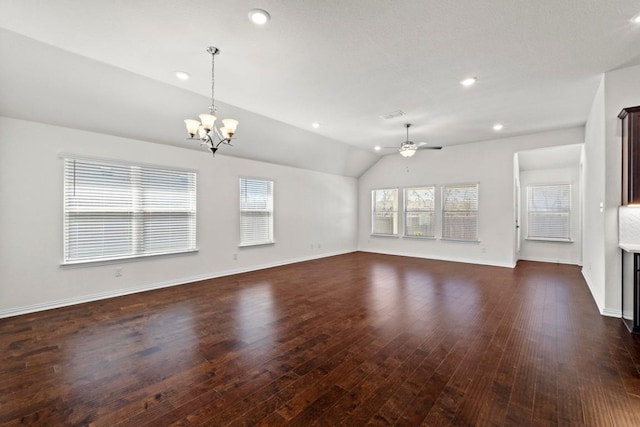 unfurnished living room with baseboards, ceiling fan with notable chandelier, dark wood finished floors, and vaulted ceiling