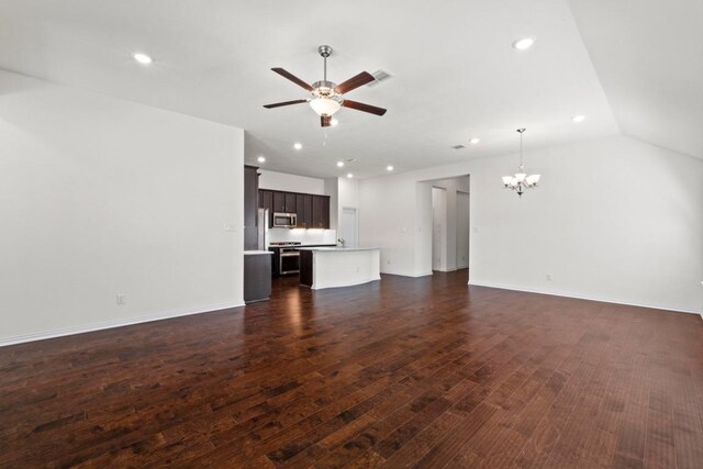 unfurnished living room featuring recessed lighting, ceiling fan with notable chandelier, dark wood-type flooring, and visible vents