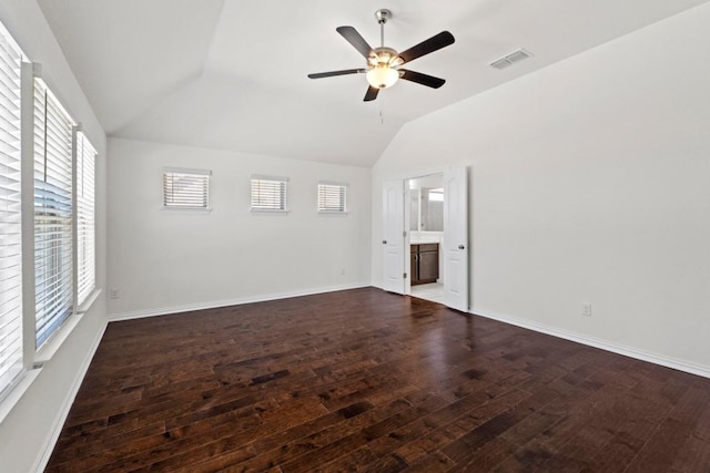 empty room with visible vents, baseboards, lofted ceiling, and hardwood / wood-style floors