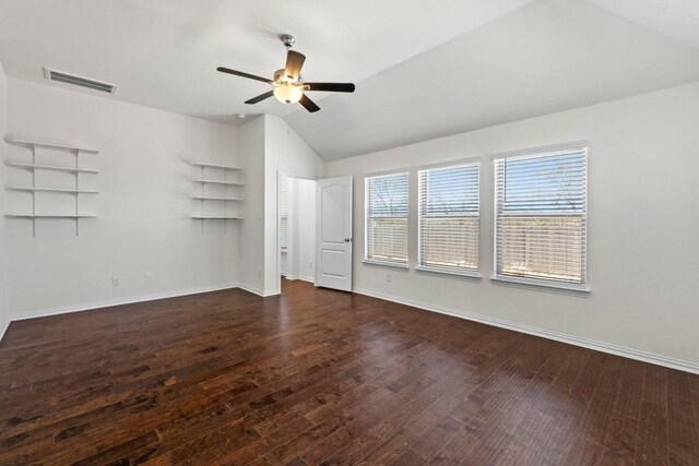 unfurnished room with visible vents, lofted ceiling, baseboards, and wood finished floors