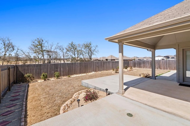 exterior space with a fenced backyard and a patio area