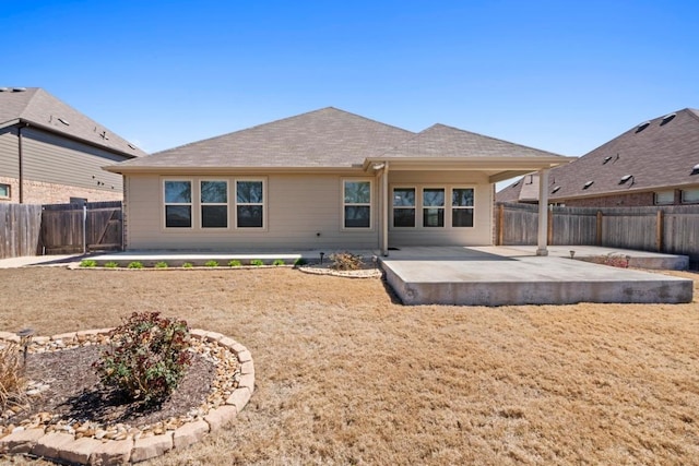 back of house featuring a patio area, a fenced backyard, and a shingled roof