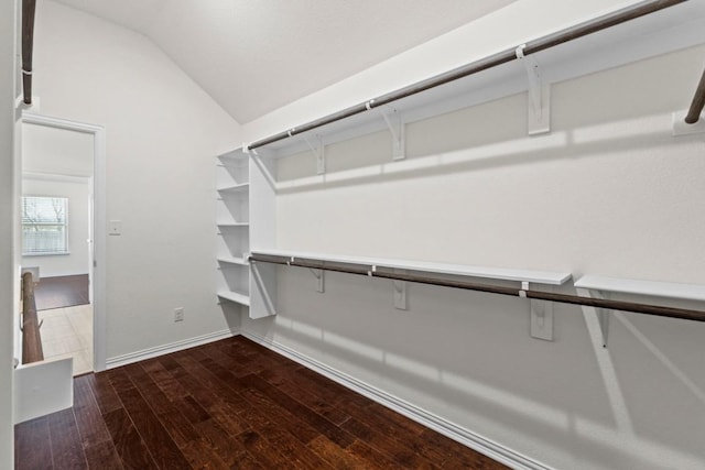 walk in closet featuring hardwood / wood-style floors and vaulted ceiling