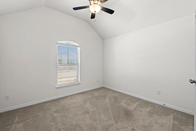 empty room with baseboards, carpet, lofted ceiling, and a ceiling fan