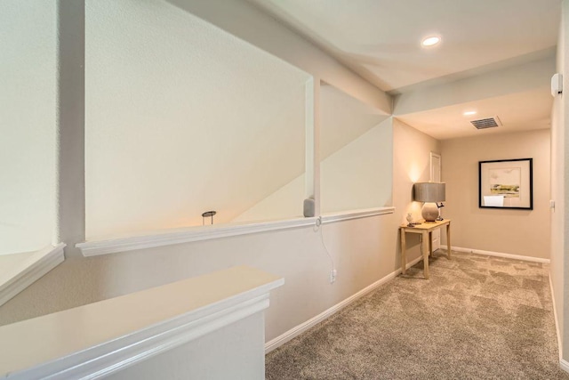 hallway with recessed lighting, carpet, visible vents, and baseboards