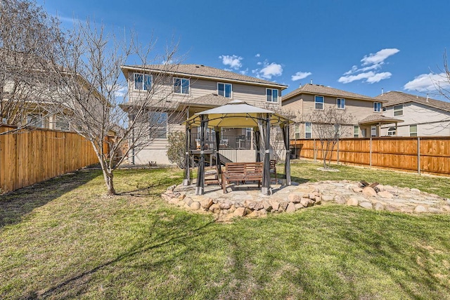 rear view of property with a gazebo, a yard, a fenced backyard, and a patio