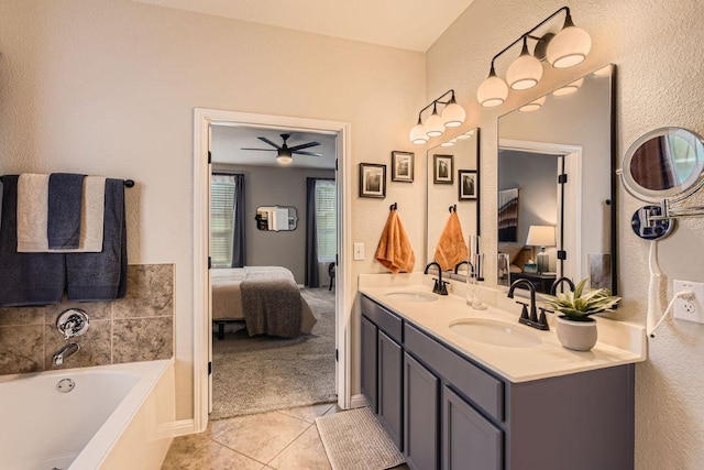 bathroom with a bath, tile patterned flooring, ensuite bath, and a sink