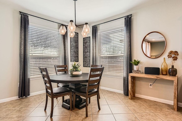 dining area with light tile patterned flooring and baseboards