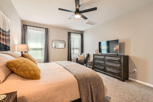 bedroom featuring a ceiling fan, carpet flooring, baseboards, and visible vents