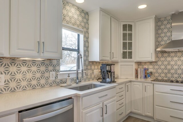 5400 Grover Ave, Austin, TX 78756 - kitchen featuring black electric stovetop, stainless steel dishwasher, backsplash, a sink, and wall chimney exhaust hood