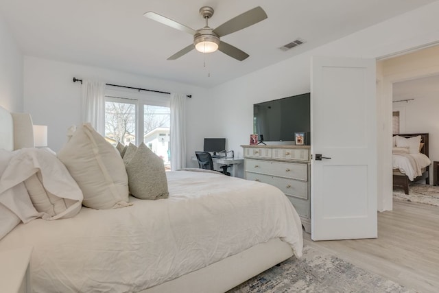 bedroom featuring visible vents, a ceiling fan, and light wood-style floors