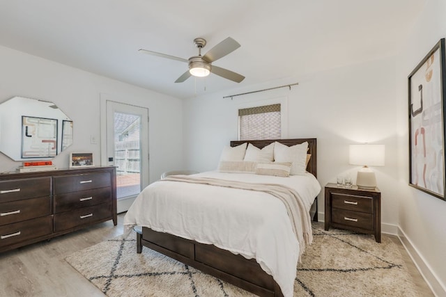 bedroom featuring access to outside, baseboards, light wood-type flooring, and ceiling fan