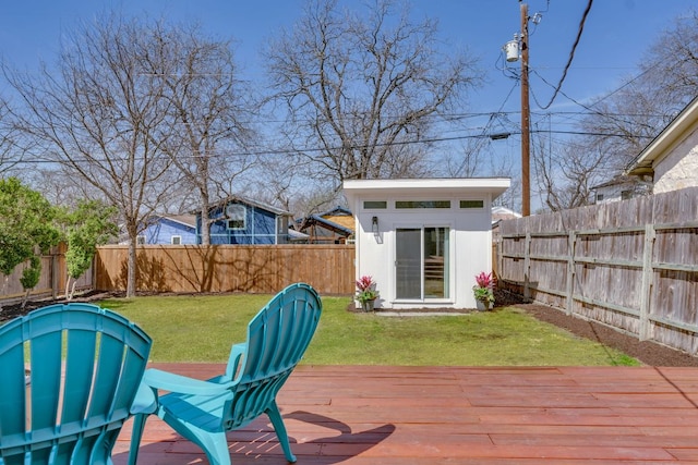 deck featuring an outdoor structure, a yard, and a fenced backyard