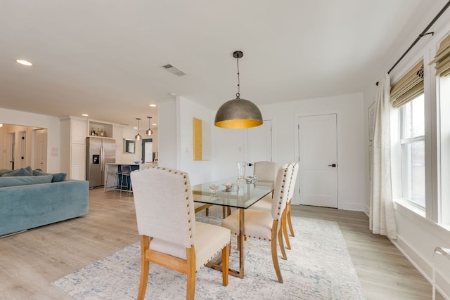 dining space with recessed lighting, visible vents, baseboards, and light wood-style floors