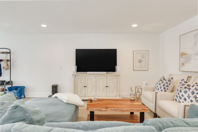 living room with recessed lighting, baseboards, and wood finished floors