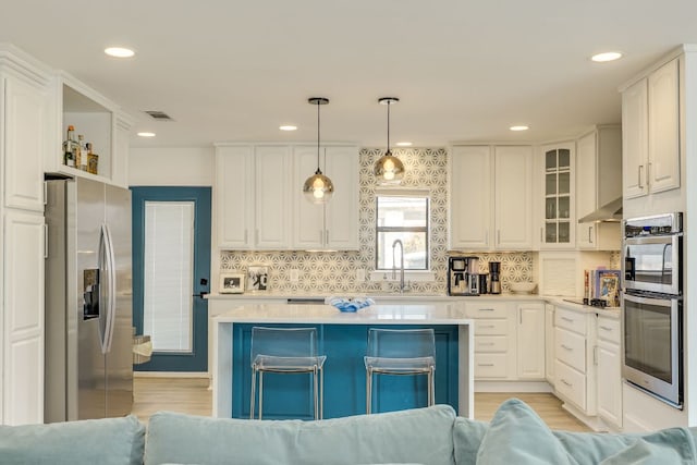 kitchen with visible vents, white cabinets, and appliances with stainless steel finishes