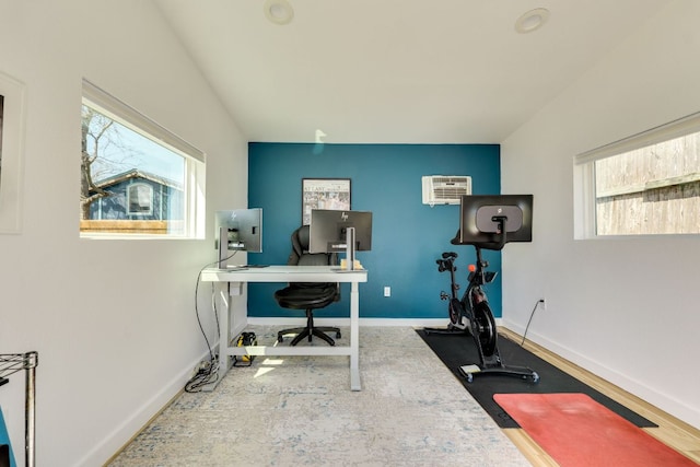 exercise area featuring baseboards and a wall mounted AC