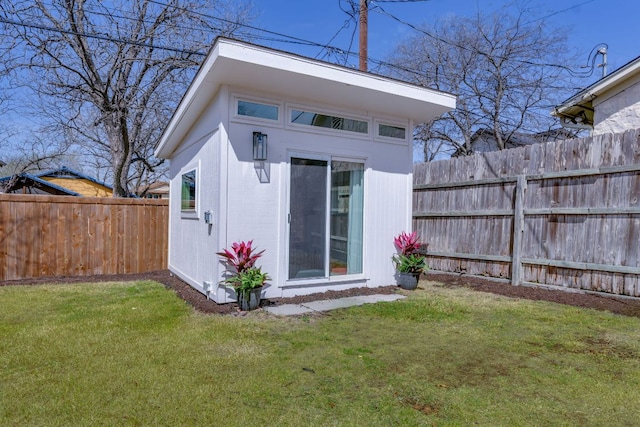 view of outbuilding with an outdoor structure and fence