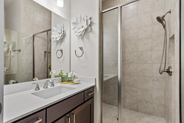 bathroom featuring a stall shower and vanity