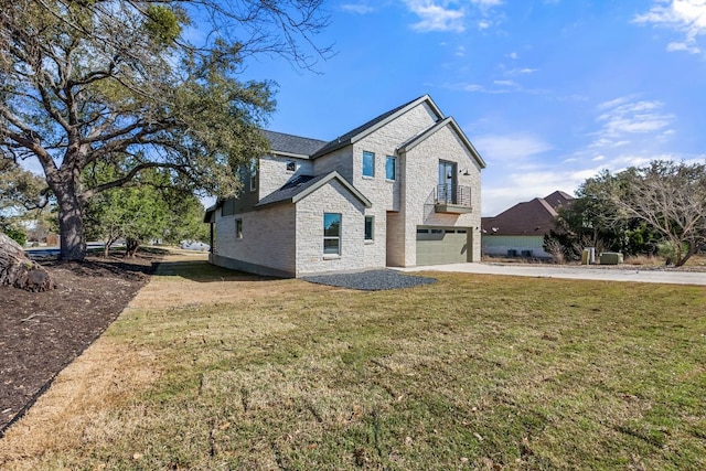 view of front of house featuring stone siding, driveway, a front yard, and a garage