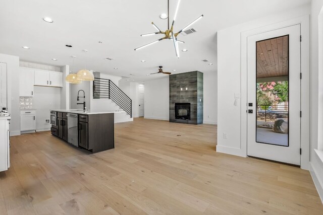 kitchen with visible vents, a sink, light countertops, light wood-style floors, and dishwasher