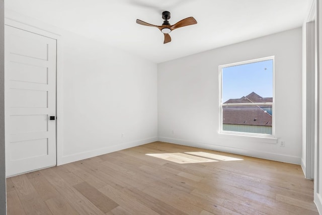 unfurnished room with light wood-style flooring, baseboards, and ceiling fan