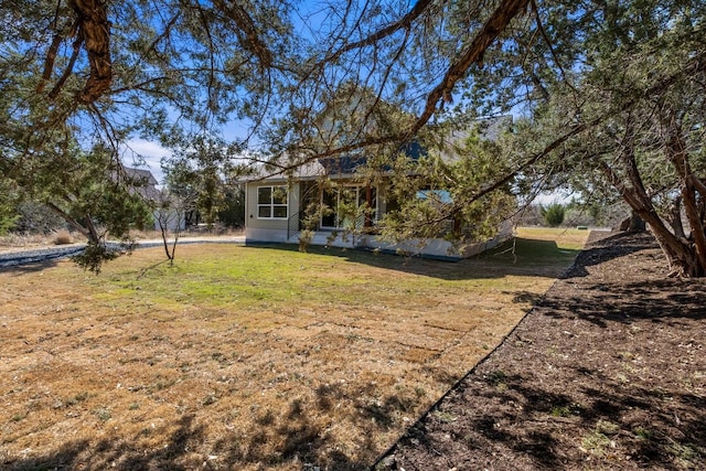 back of property with a lawn