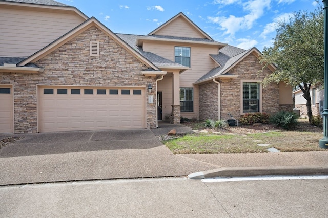 craftsman inspired home featuring a garage, stone siding, driveway, and a shingled roof