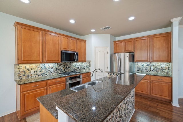 4229 Johns Light Dr, Austin, TX 78727 - kitchen with stainless steel appliances, a sink, brown cabinets, dark wood-type flooring, and recessed lighting