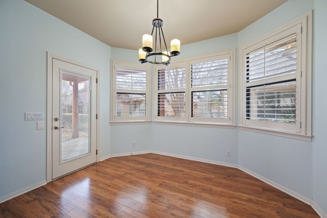 4229 Johns Light Dr, Austin, TX 78727 - unfurnished dining area featuring a chandelier, wood finished floors, and baseboards