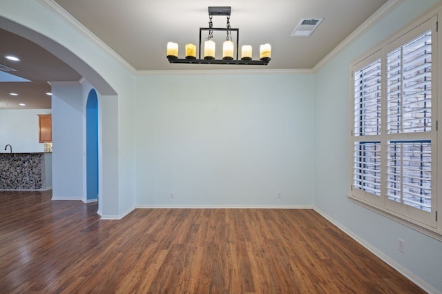 unfurnished room featuring visible vents, baseboards, dark wood-type flooring, and ornamental molding