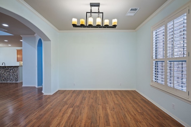 4229 Johns Light Dr, Austin, TX 78727 - unfurnished dining area featuring dark wood-style flooring, baseboards, arched walkways, and crown molding