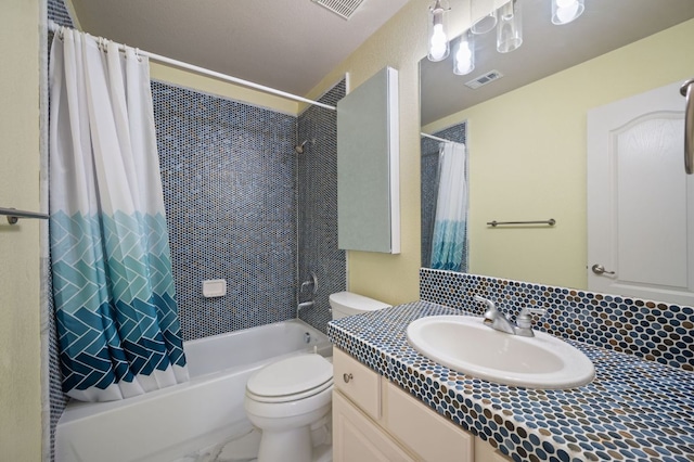 bathroom featuring visible vents, vanity, toilet, and shower / tub combo with curtain