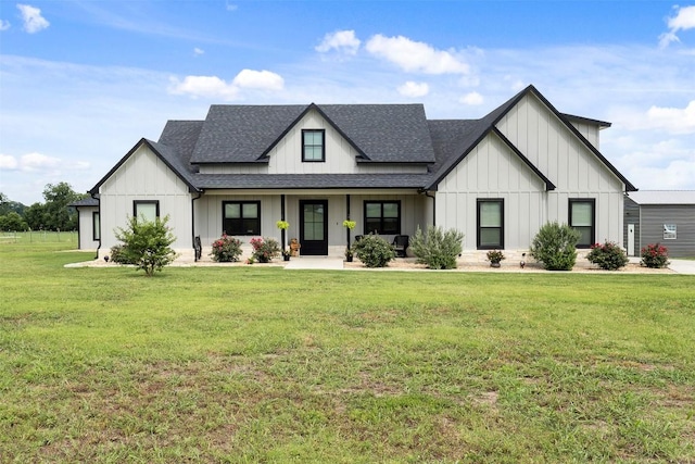 modern farmhouse featuring board and batten siding, a shingled roof, and a front yard