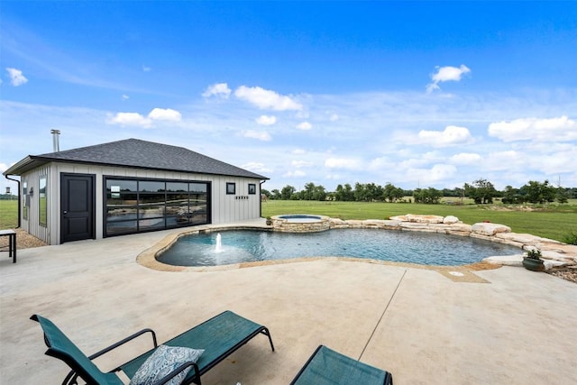 view of pool featuring a pool with connected hot tub, a storage structure, a yard, an outbuilding, and a patio