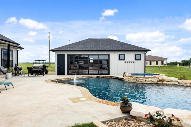 view of swimming pool with an exterior structure, a patio, a pool with connected hot tub, and an outdoor structure