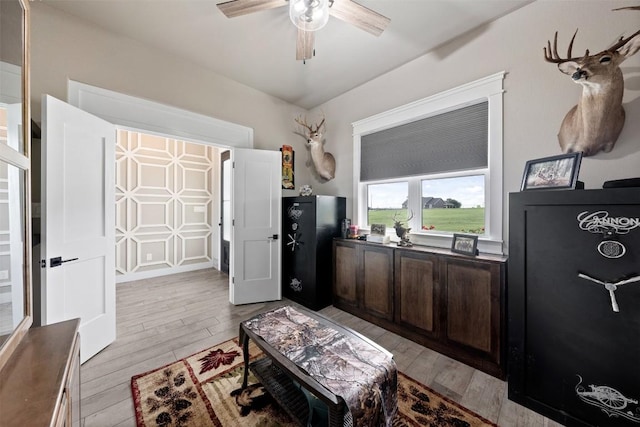 interior space featuring dark countertops, dark brown cabinets, light wood-style flooring, and a ceiling fan