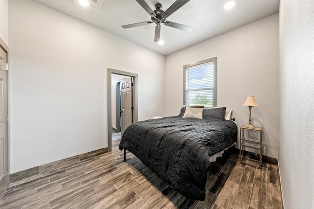 bedroom with wood finish floors, baseboards, recessed lighting, and a ceiling fan