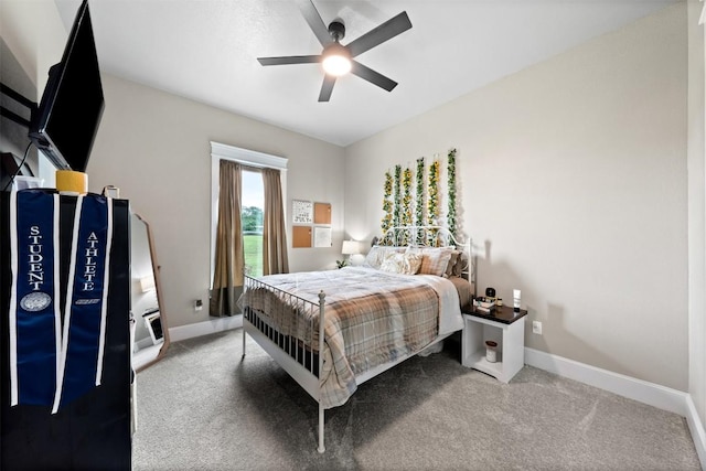 carpeted bedroom with a ceiling fan and baseboards