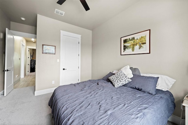 carpeted bedroom featuring visible vents, baseboards, and ceiling fan