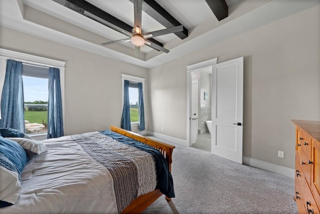 carpeted bedroom featuring beamed ceiling, a tray ceiling, and baseboards