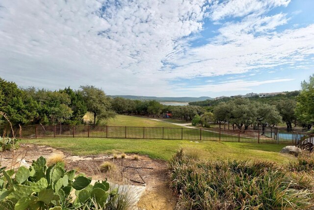 view of yard with a rural view and fence